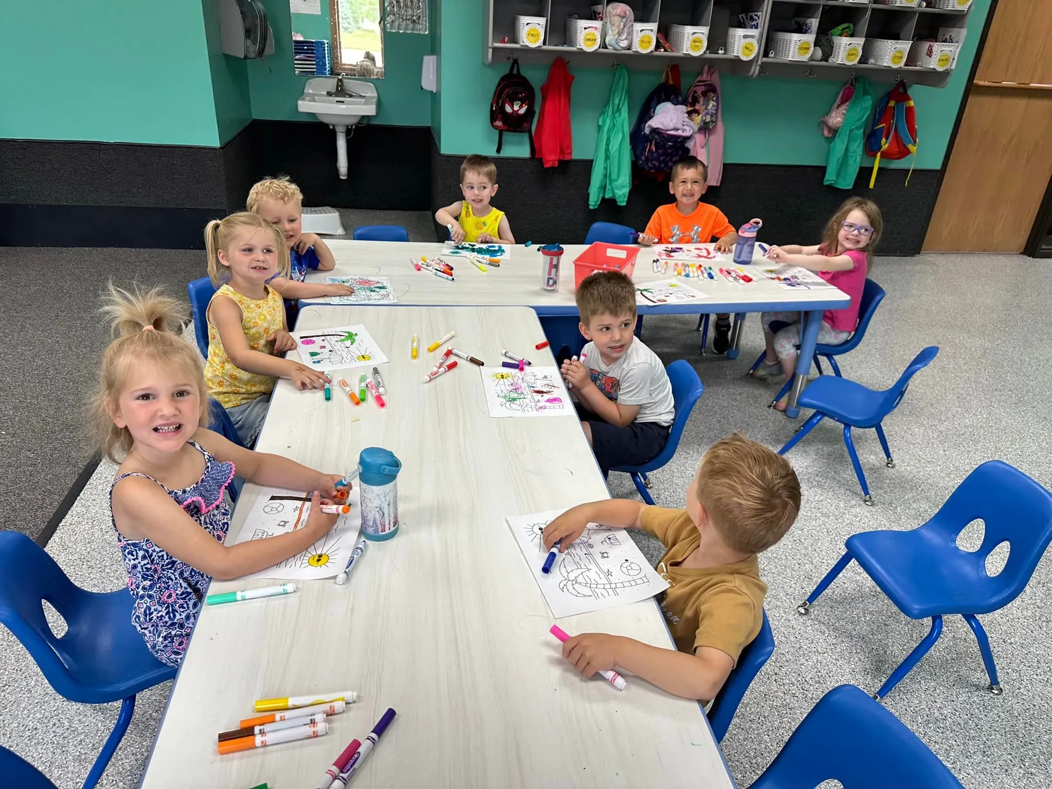 Children at a table doing a drawing activity